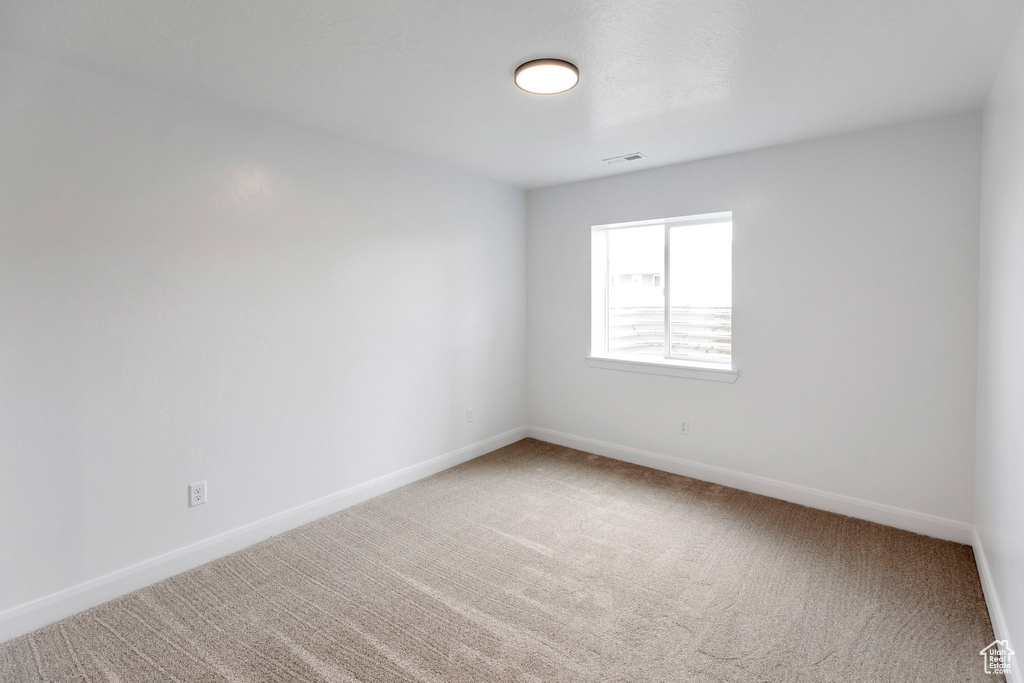 Empty room with carpet flooring