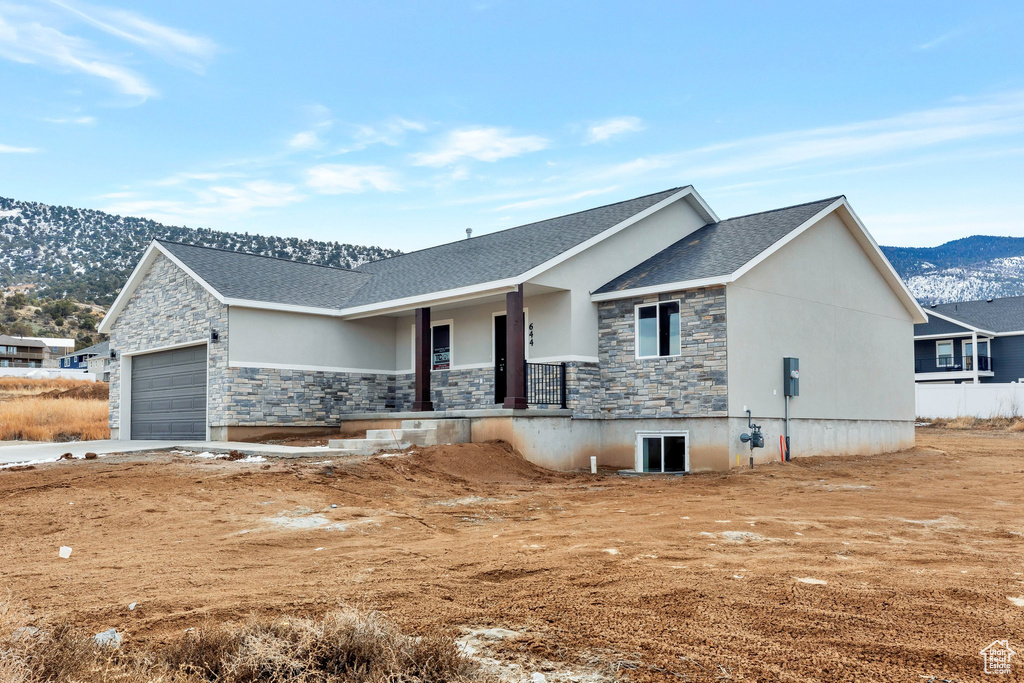 View of front of house with a garage and a mountain view