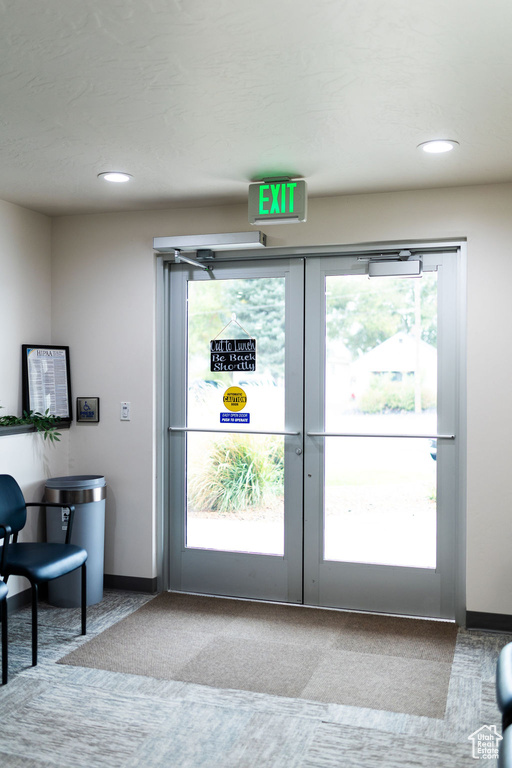 Doorway featuring light carpet