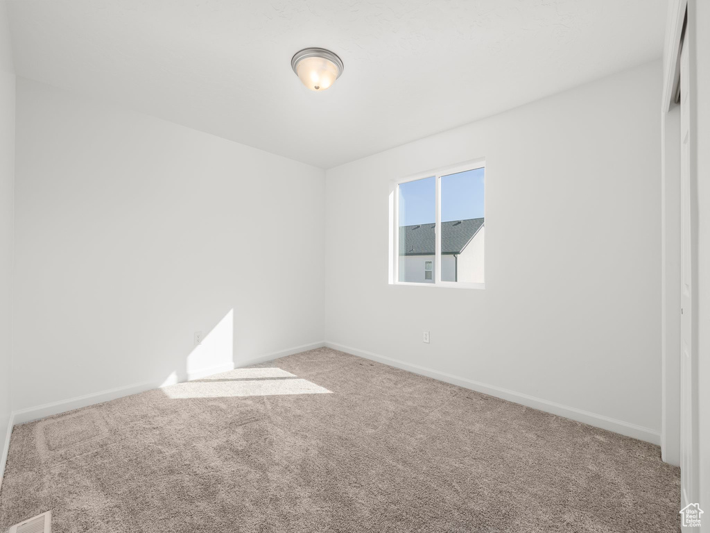 Empty room featuring carpet flooring