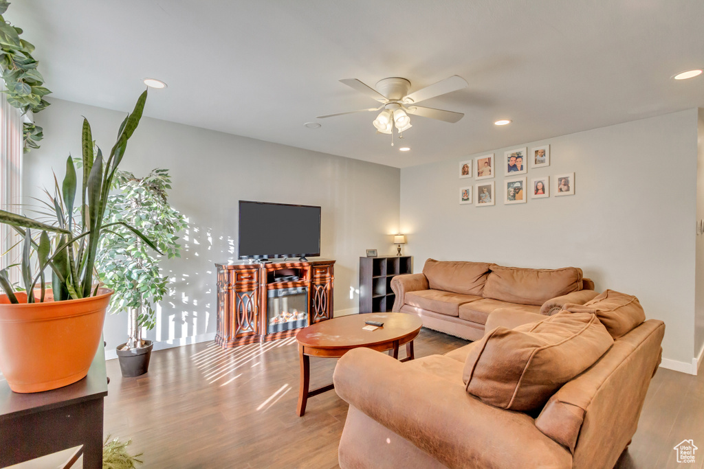 Living room featuring light hardwood / wood-style floors and ceiling fan