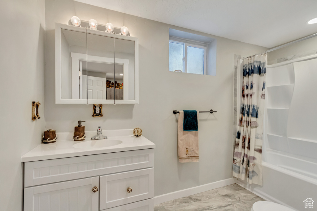 Full bathroom with shower / tub combo, vanity, and toilet