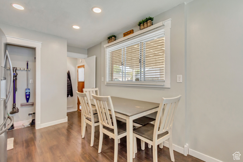 Dining room with dark hardwood / wood-style floors