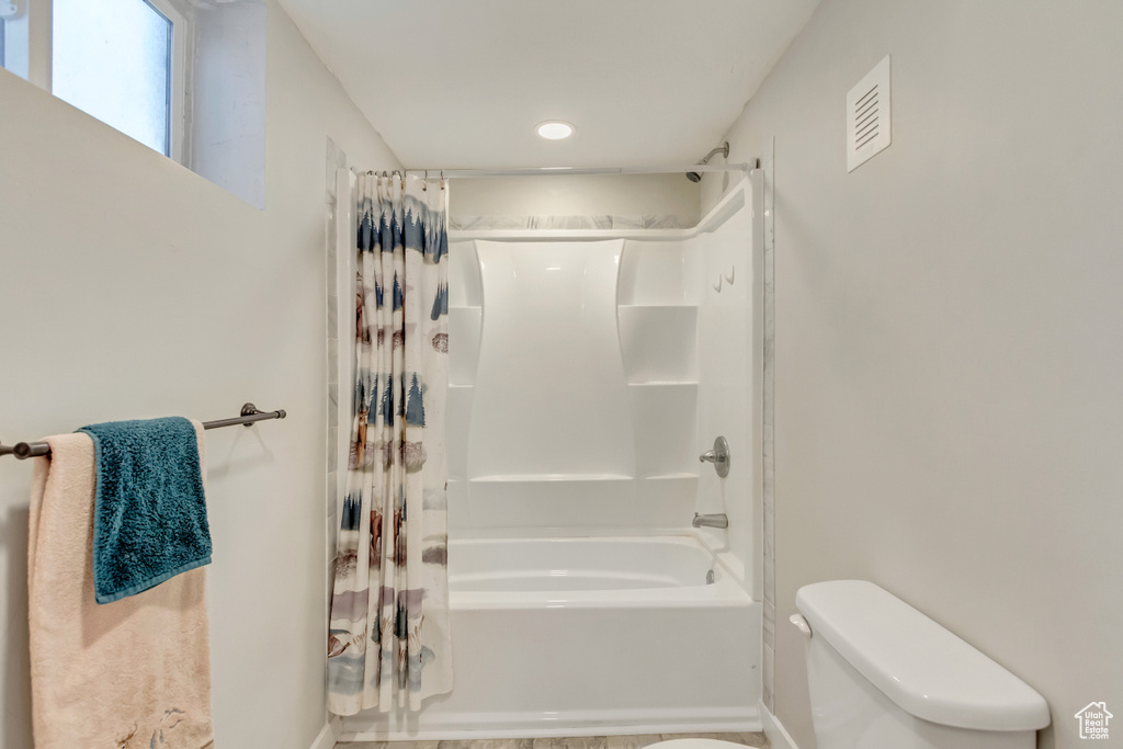 Bathroom with shower / bath combo and toilet