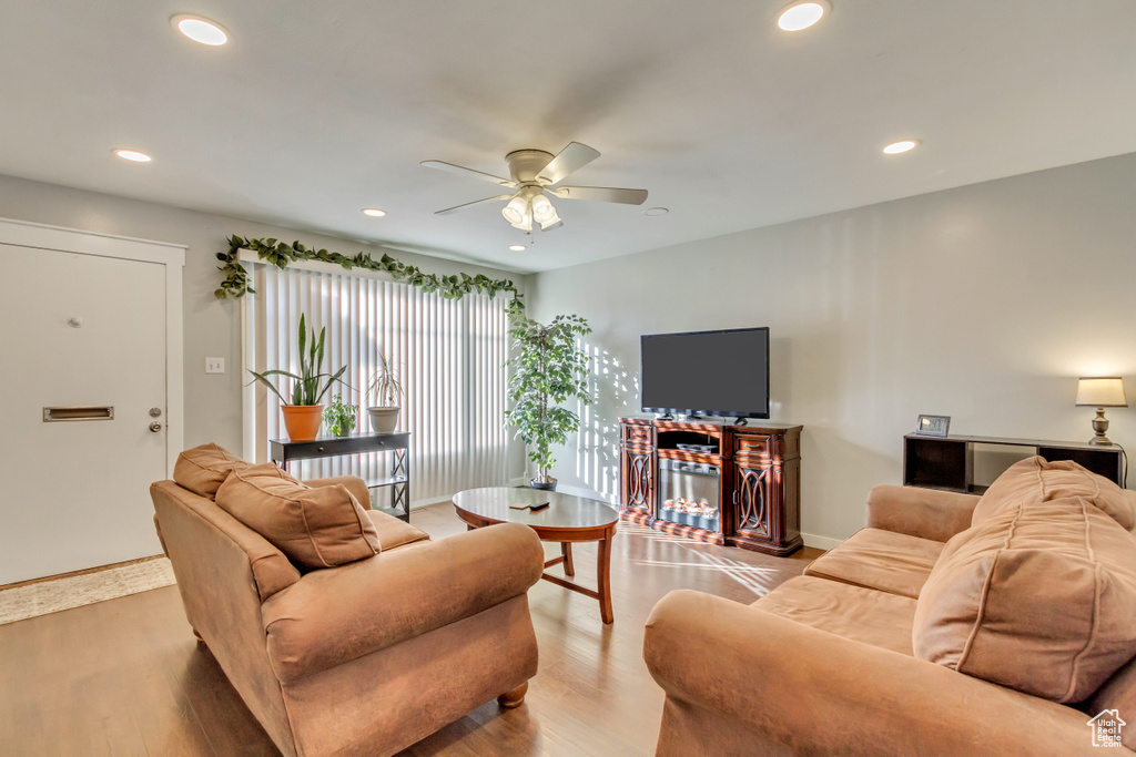 Living room featuring ceiling fan and light hardwood / wood-style floors