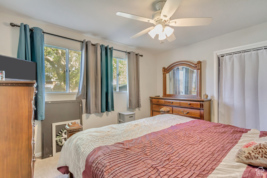 Carpeted bedroom with ceiling fan