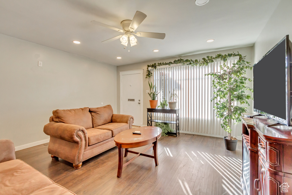 Living room featuring ceiling fan and hardwood / wood-style floors