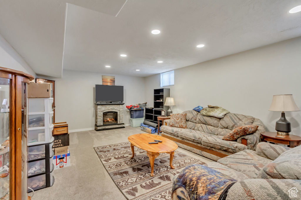 Living room with light carpet and a stone fireplace