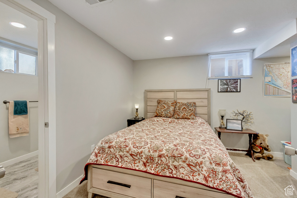 Bedroom featuring light colored carpet