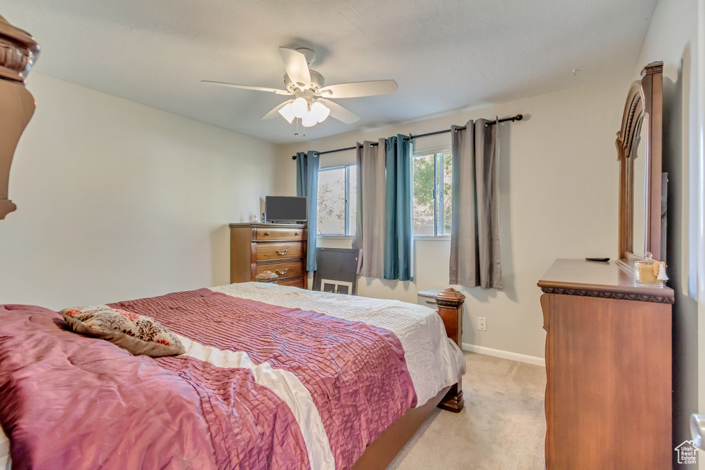 Bedroom featuring ceiling fan and light colored carpet