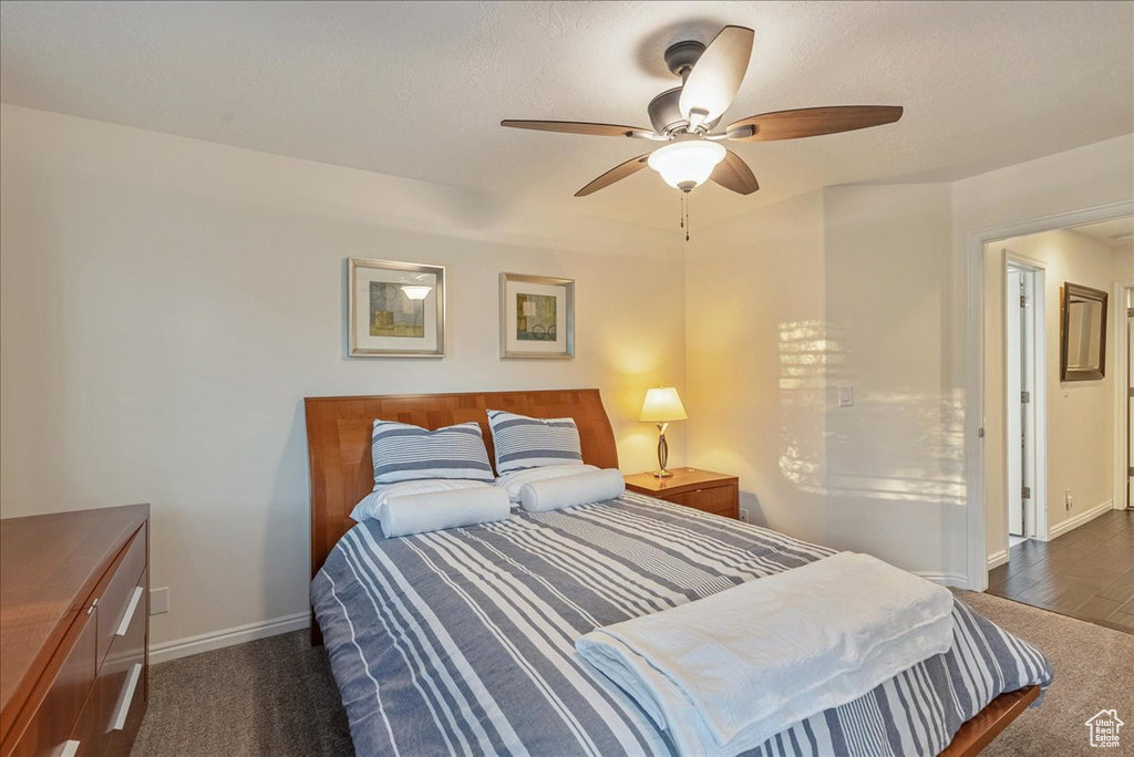 Bedroom featuring ceiling fan and dark wood-type flooring