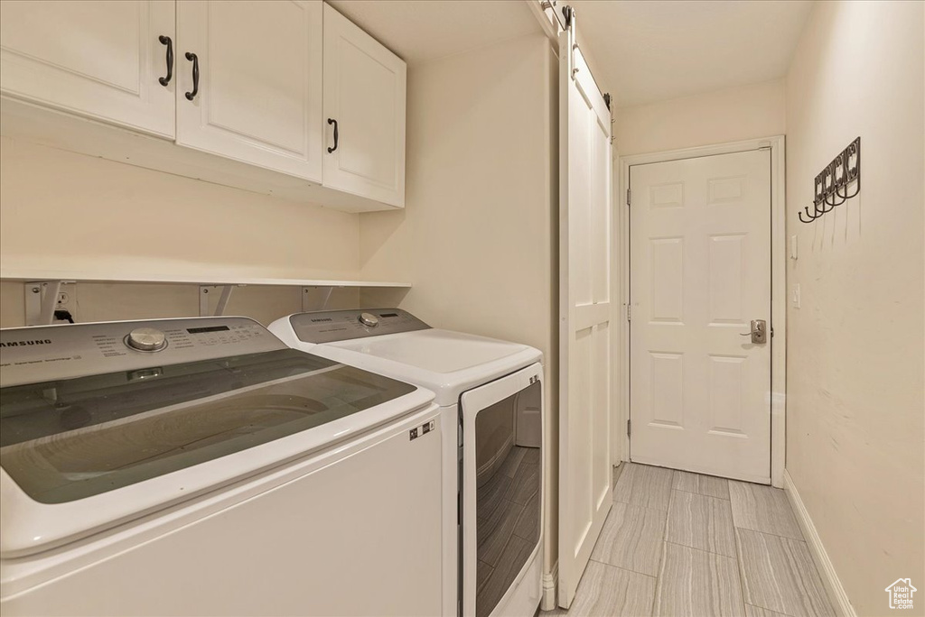 Laundry room with washing machine and dryer and cabinets