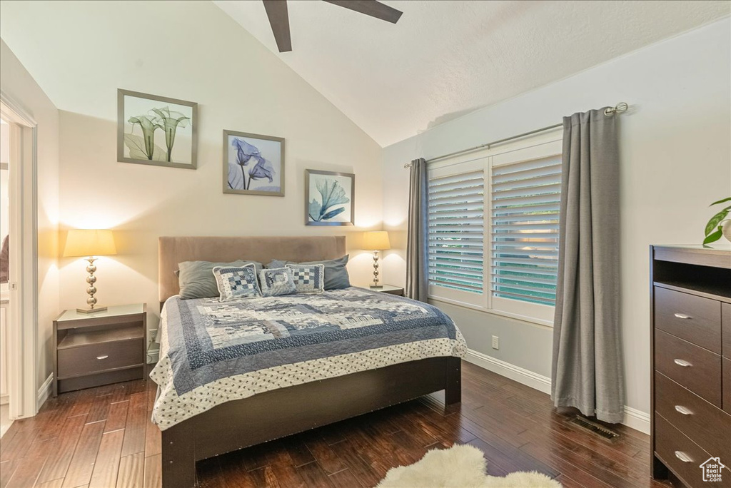 Bedroom featuring ceiling fan, lofted ceiling, and dark hardwood / wood-style floors