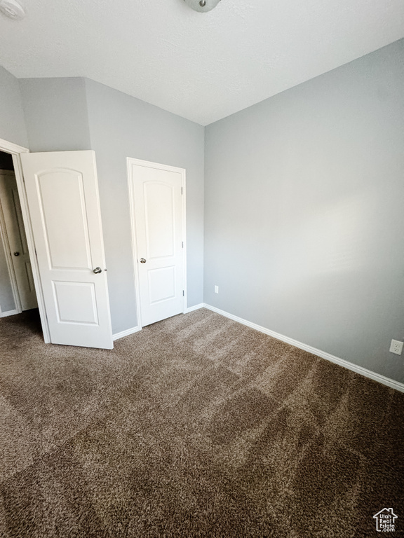 Unfurnished bedroom with carpet flooring