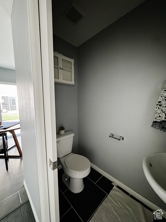 Bathroom featuring toilet and tile patterned floors