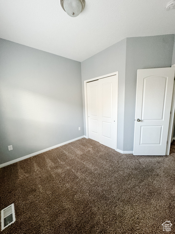 Unfurnished bedroom featuring carpet and a closet