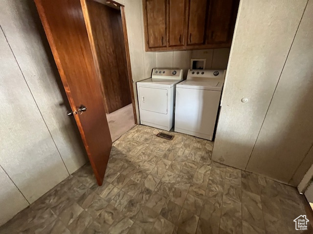 Washroom featuring washer and dryer and cabinets