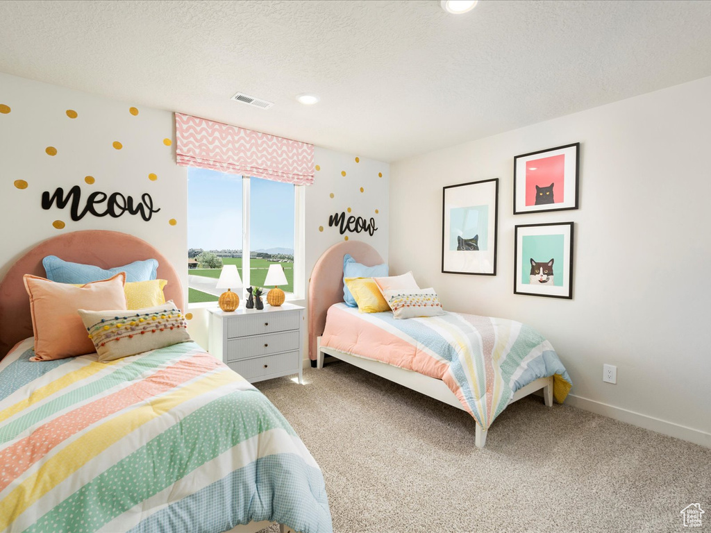 Bedroom with carpet and a textured ceiling