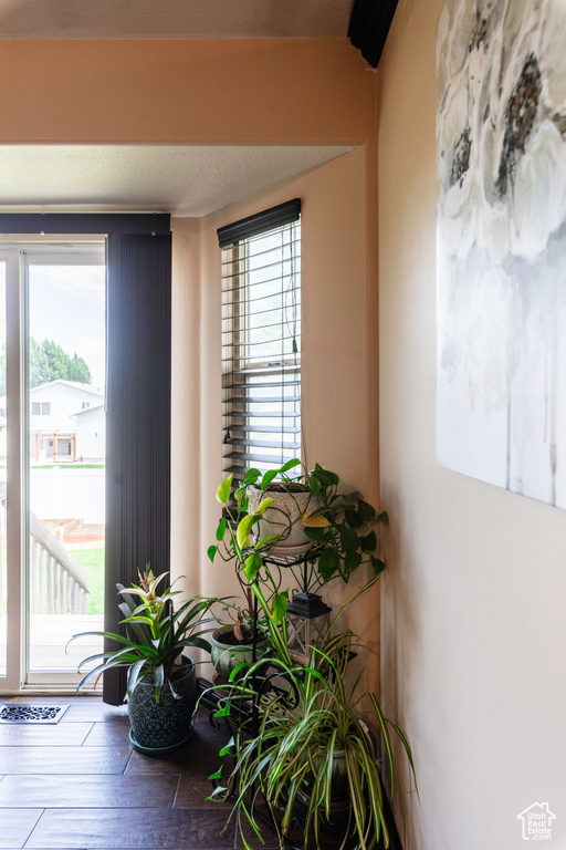 Foyer entrance with hardwood / wood-style floors and a textured ceiling