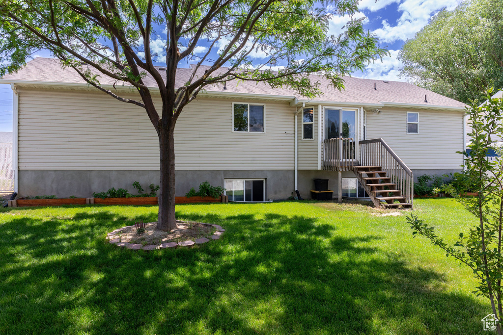 Rear view of property featuring a lawn