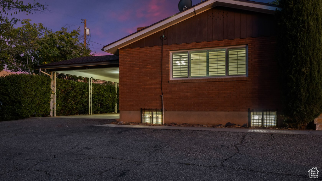 Property exterior at dusk with a carport