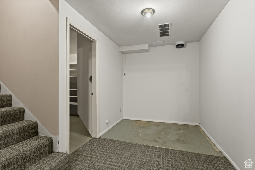 Unfurnished room featuring concrete flooring