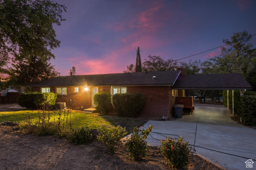 Ranch-style house featuring a carport