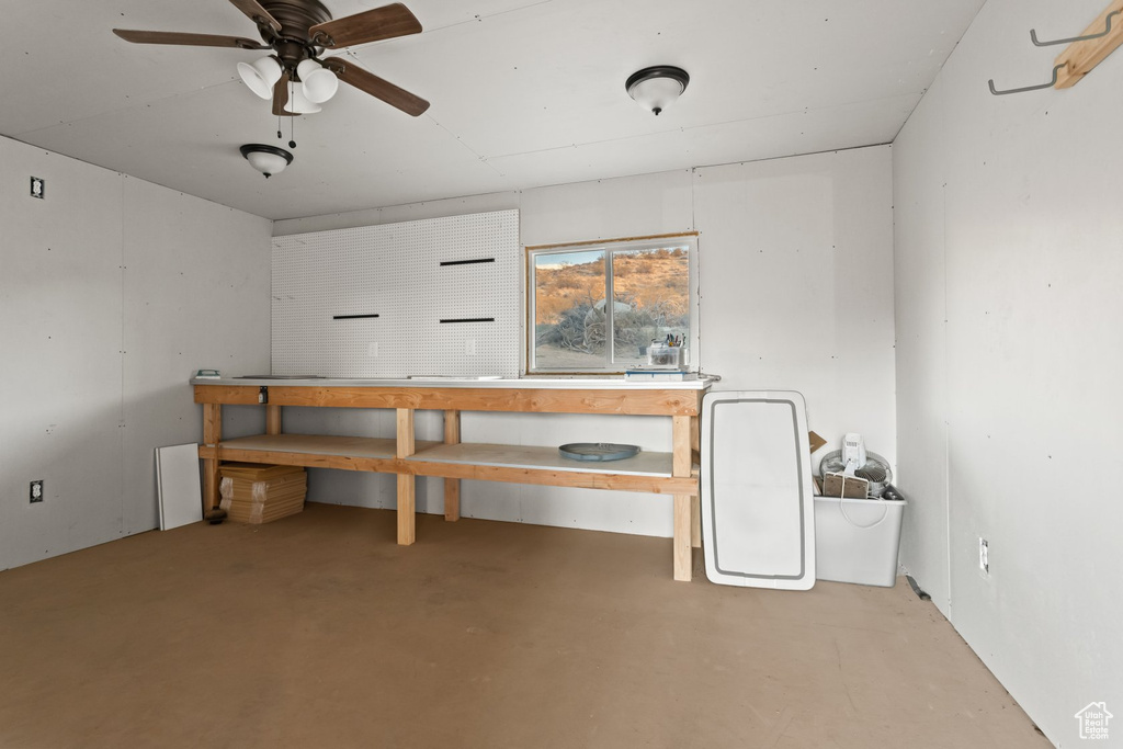 Interior space featuring ceiling fan and a workshop area