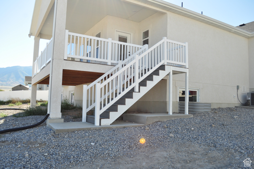 View of side of home with a mountain view