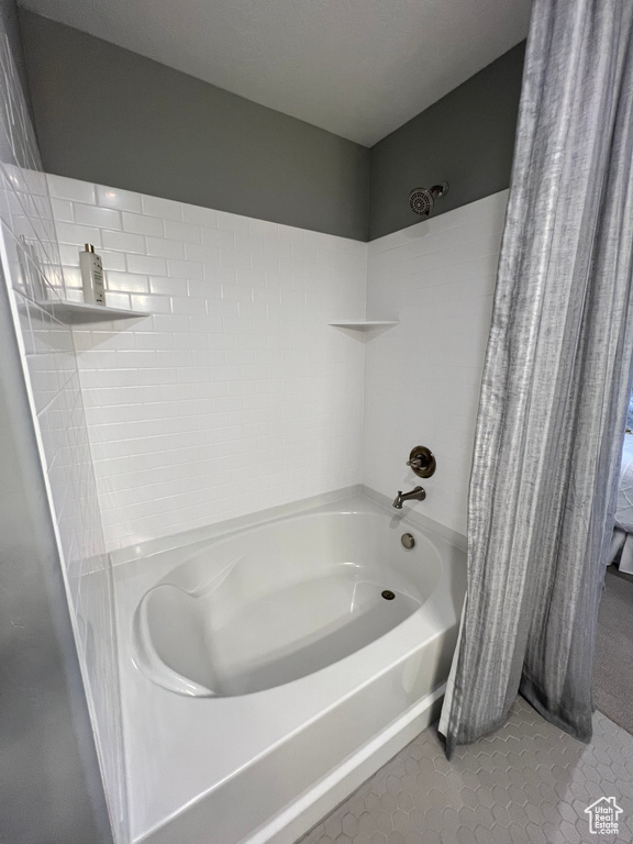 Bathroom with shower / bath combination with curtain and tile patterned flooring