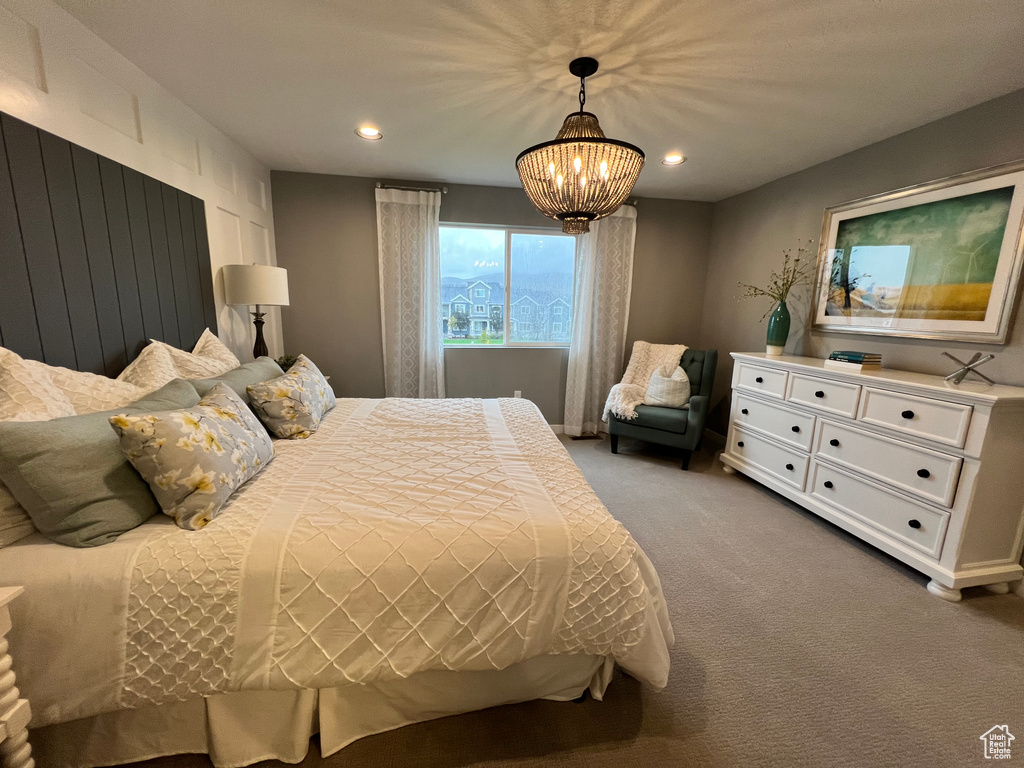 Bedroom with carpet floors and an inviting chandelier