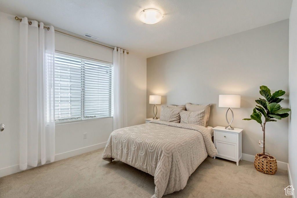 Bedroom with light carpet