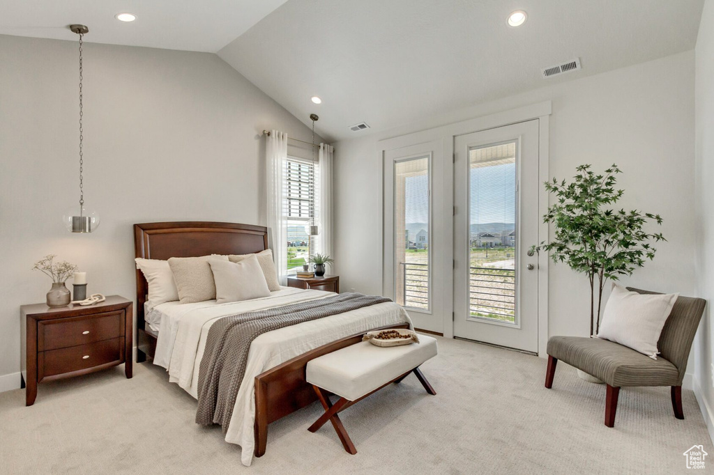 Bedroom featuring lofted ceiling, light carpet, and access to outside