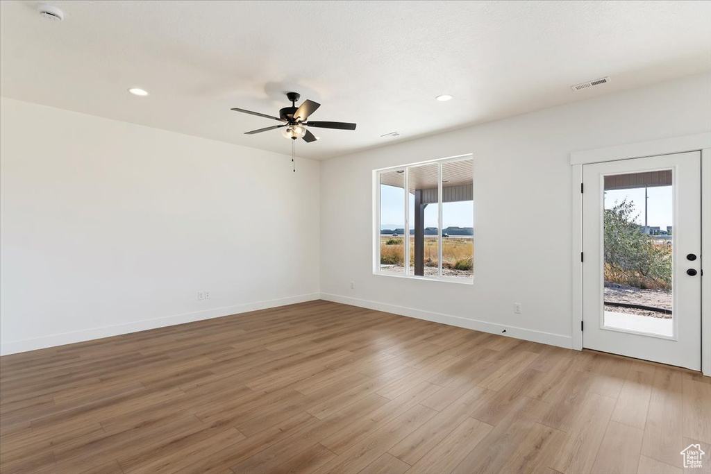 Unfurnished room featuring ceiling fan and light hardwood / wood-style flooring