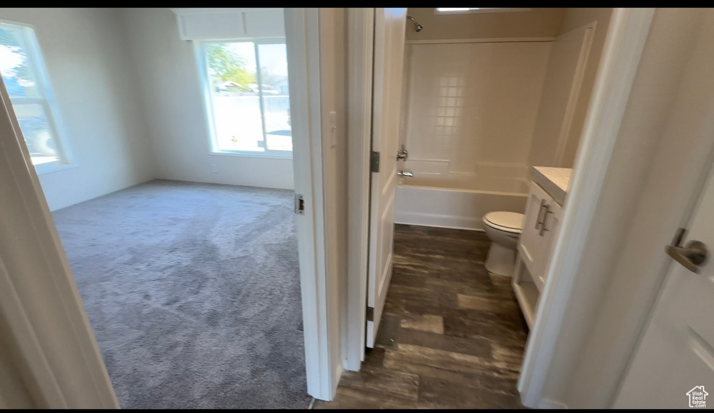 Full bathroom with washtub / shower combination, vanity, and toilet