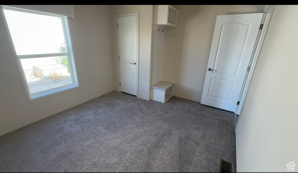 Unfurnished bedroom with carpet