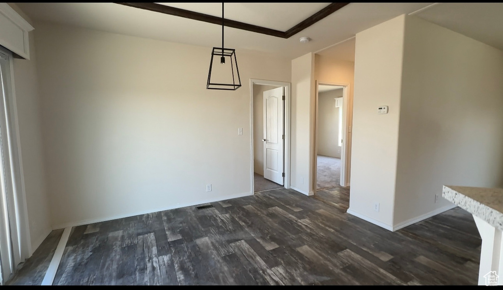 Unfurnished dining area with dark hardwood / wood-style flooring