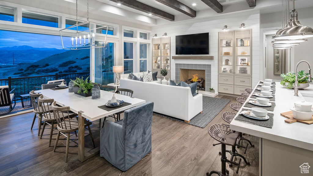 Interior space featuring hardwood / wood-style flooring, beamed ceiling, and a fireplace