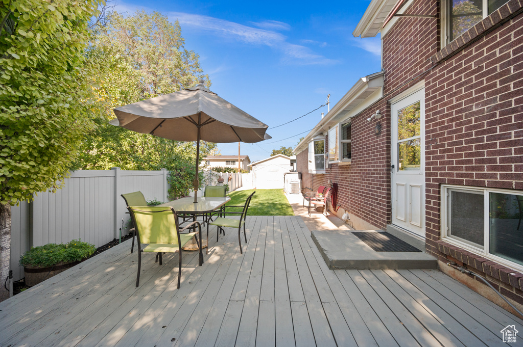 Wooden deck featuring a storage unit