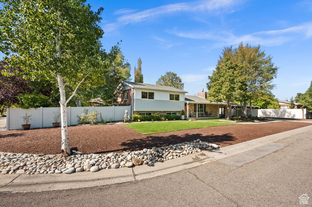 Tri-level home with a front yard