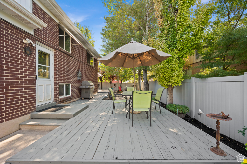 Wooden terrace featuring area for grilling