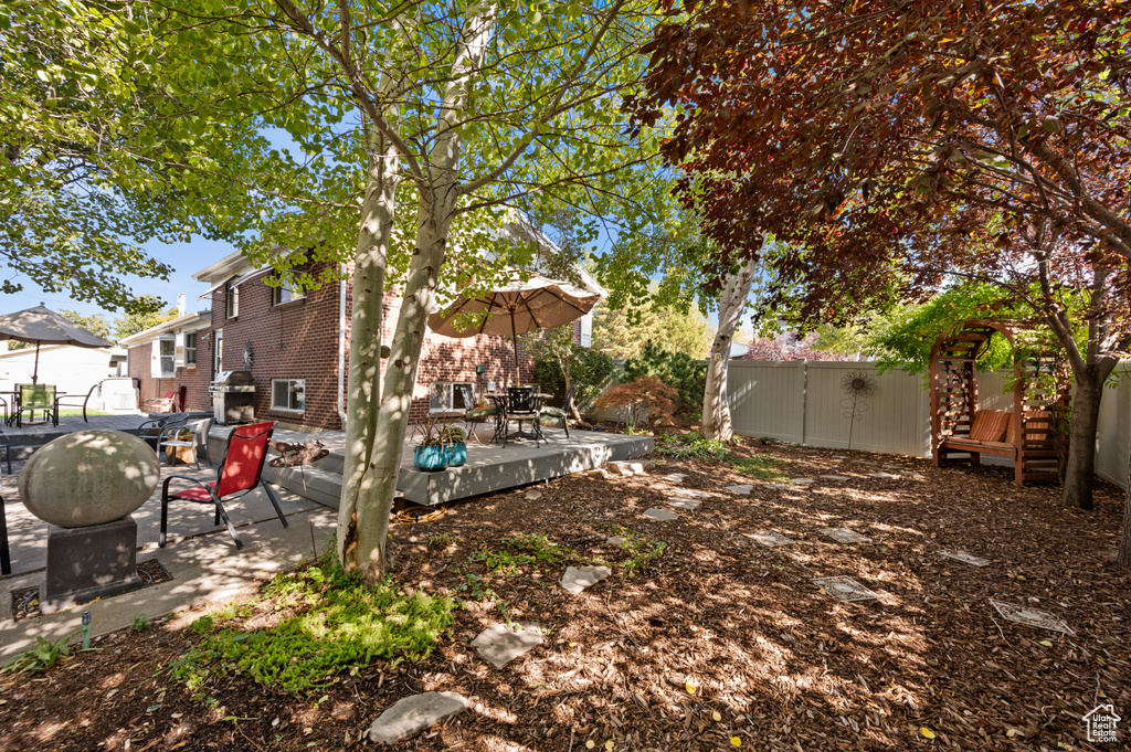 View of yard featuring a patio area and a deck