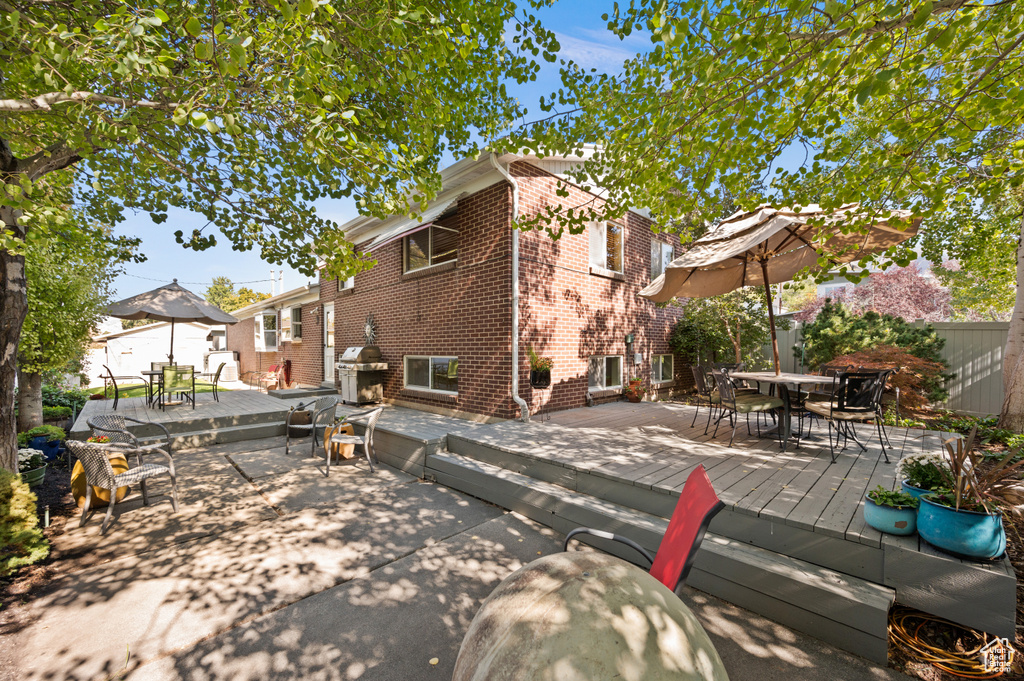 Back of house featuring a wooden deck