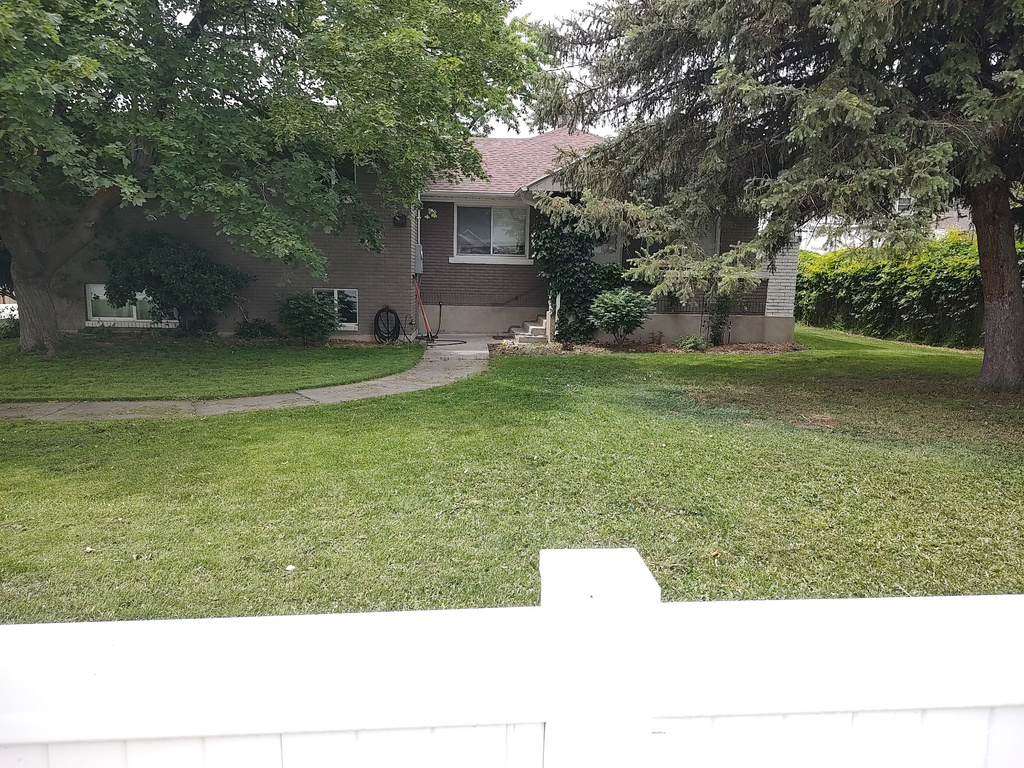 View of front of home featuring brick siding and a front yard