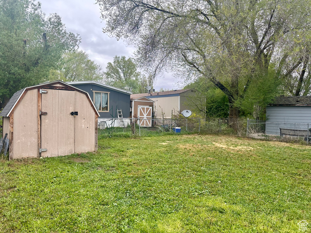 View of yard with a storage unit