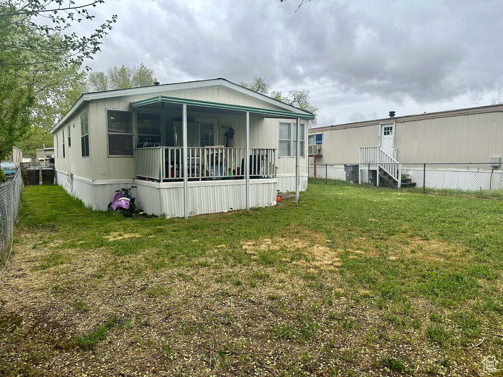 Back of property featuring a yard