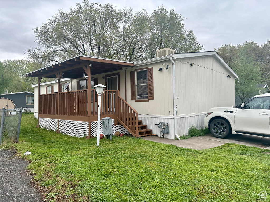 Exterior space featuring a deck and a front yard