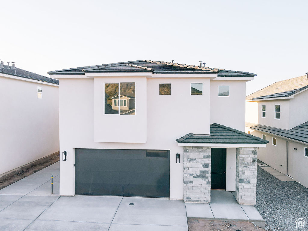 View of front facade featuring a garage