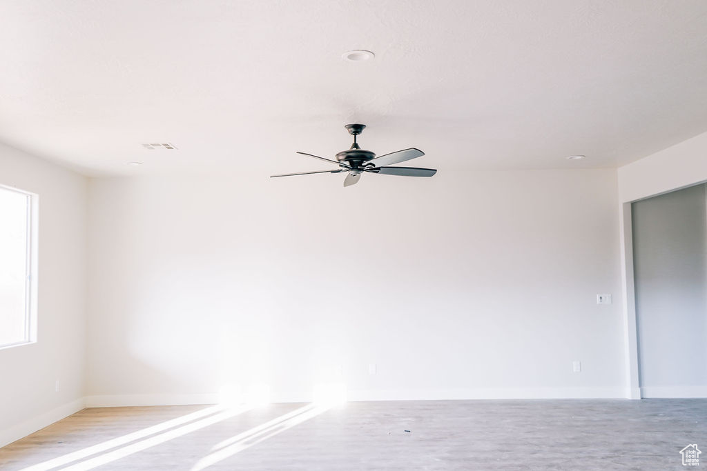 Empty room featuring ceiling fan and light hardwood / wood-style flooring