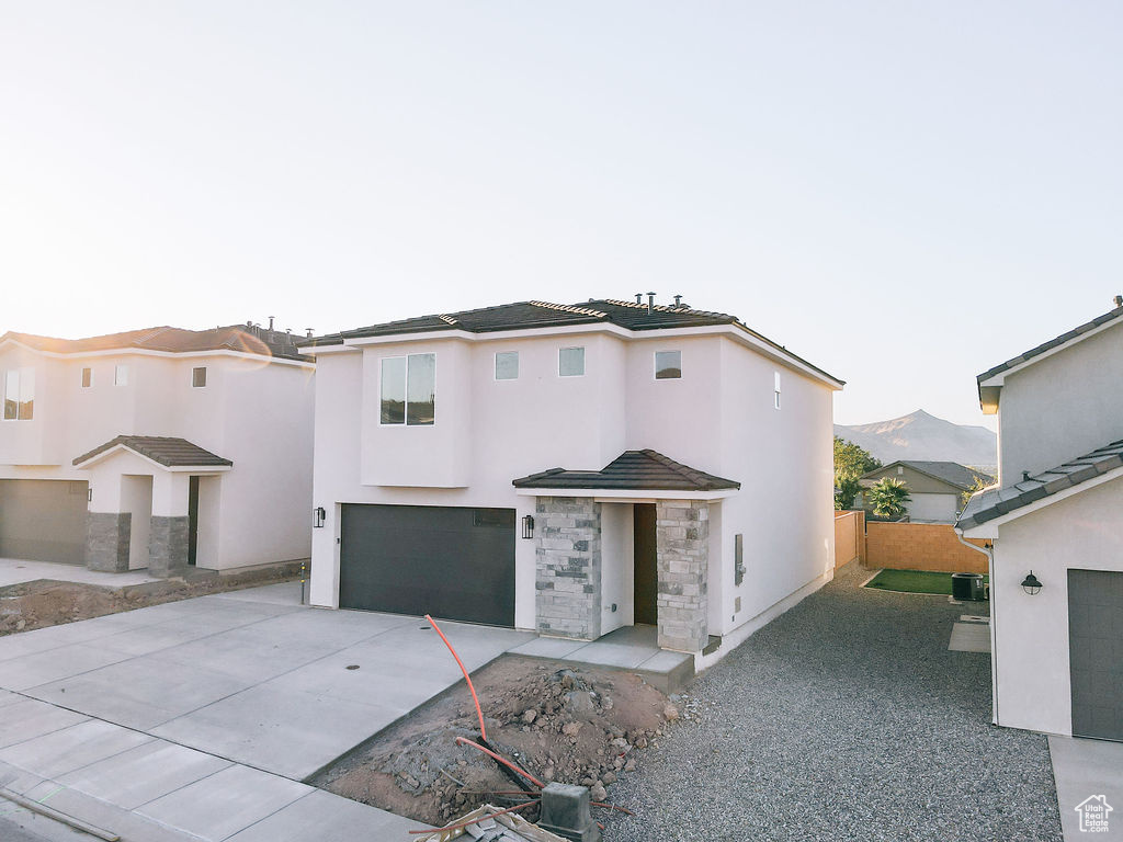 View of front of house featuring a garage and a mountain view